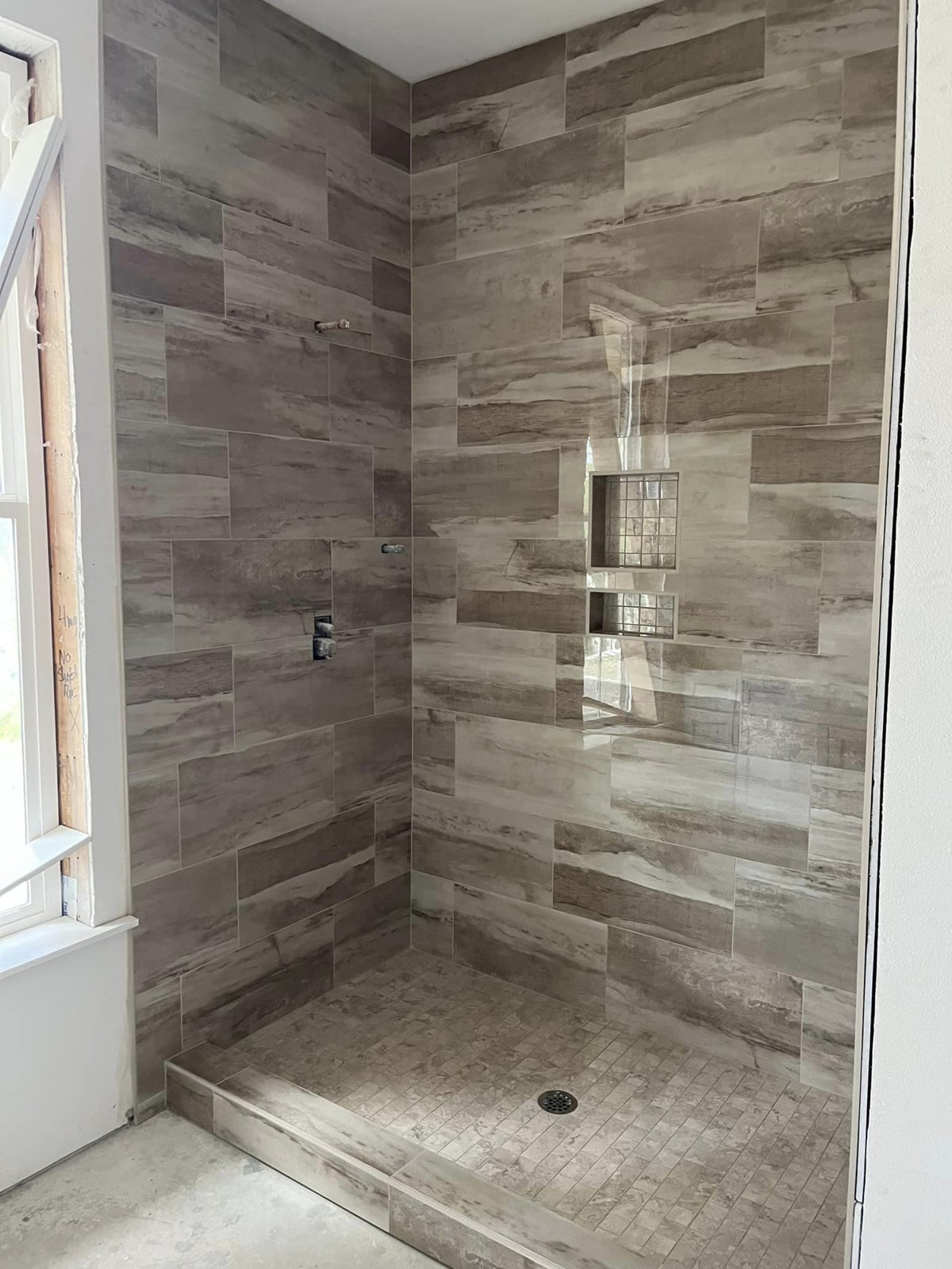 Custom tiled walk-in shower — interior remodel work by American Roofing & Construction