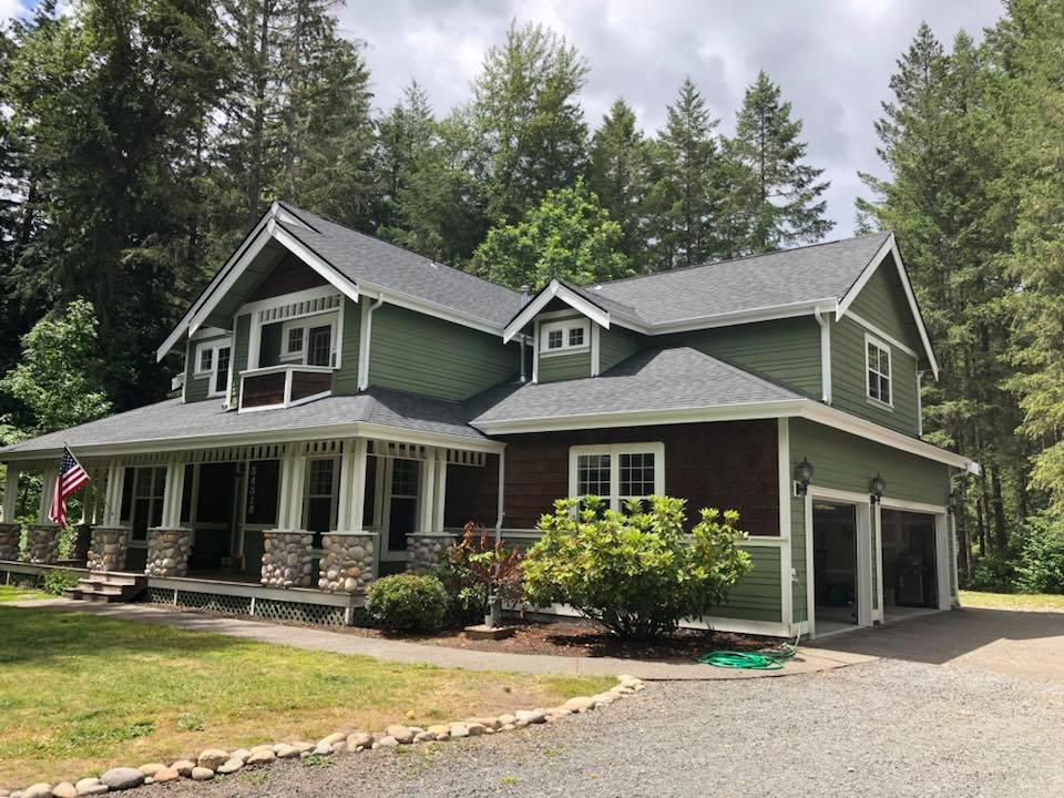 Craftsman home with a new architectural-shingle roof by American Roofing & Construction, American flag on the porch